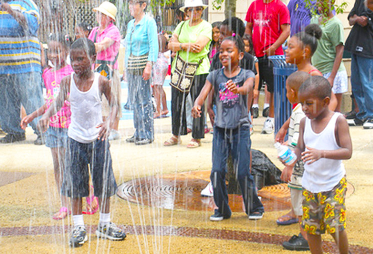 Children playing in splash fountain Opening Day