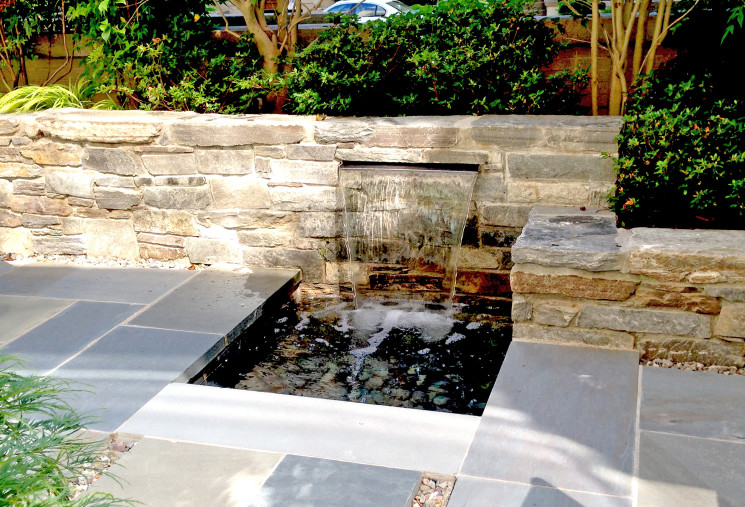 Patio fountain with stone wall and bluestone patio