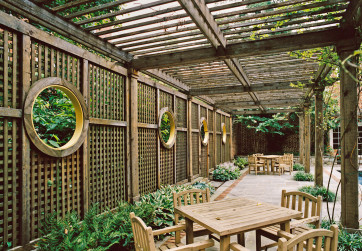 Poolside arbor provides shade and dining area