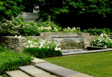 Beautiful stone fountain is center piece of back garden