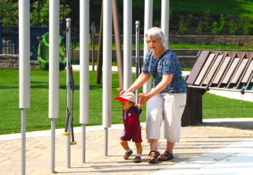 Grandmother and grandson exploring the musical play area