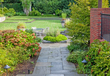 Refined stone path leads to garden and pool
