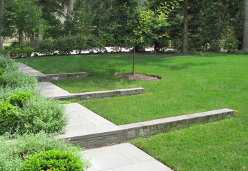 A refined series of steps and retaining walls address a sloping front lawn