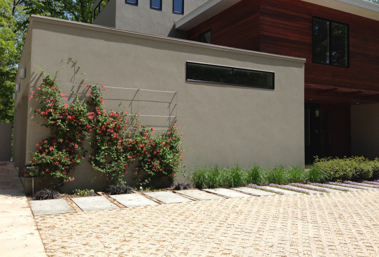The permeable pavers of this drive allow for water to percolate into soil