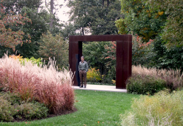 Modern meadow in fall with sculpture